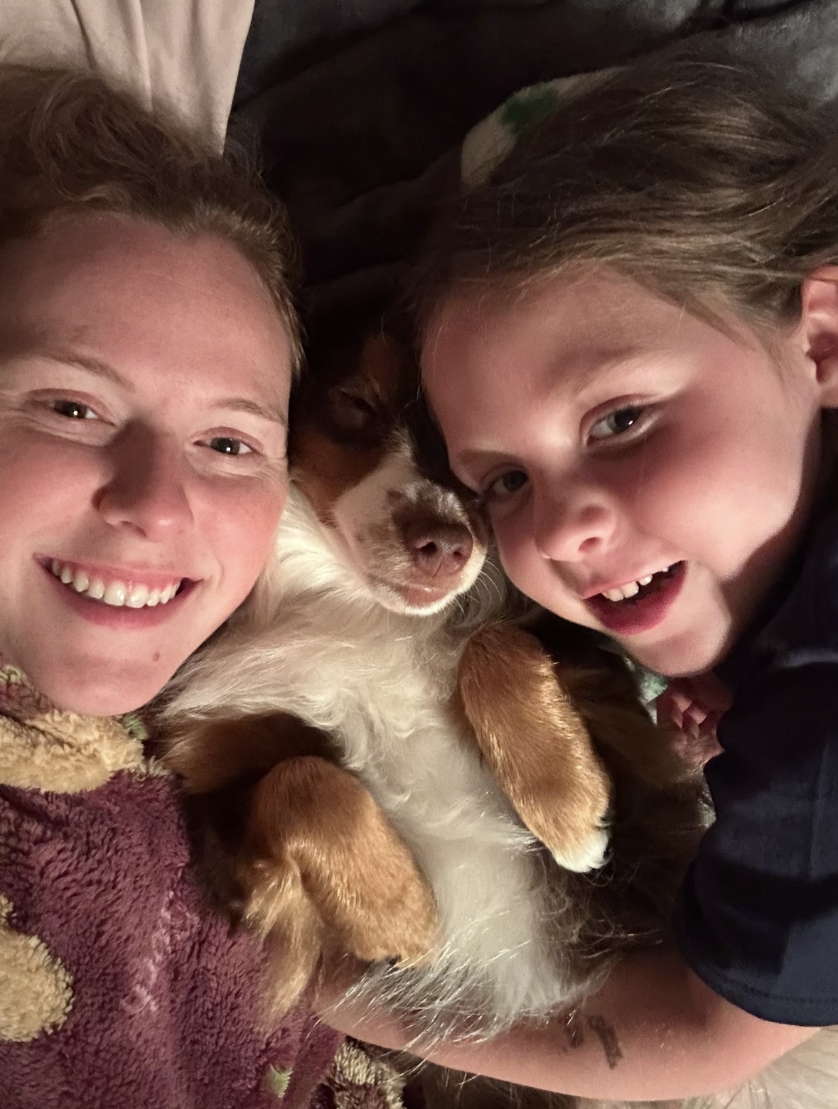 Bear nestled affectionately between two family members